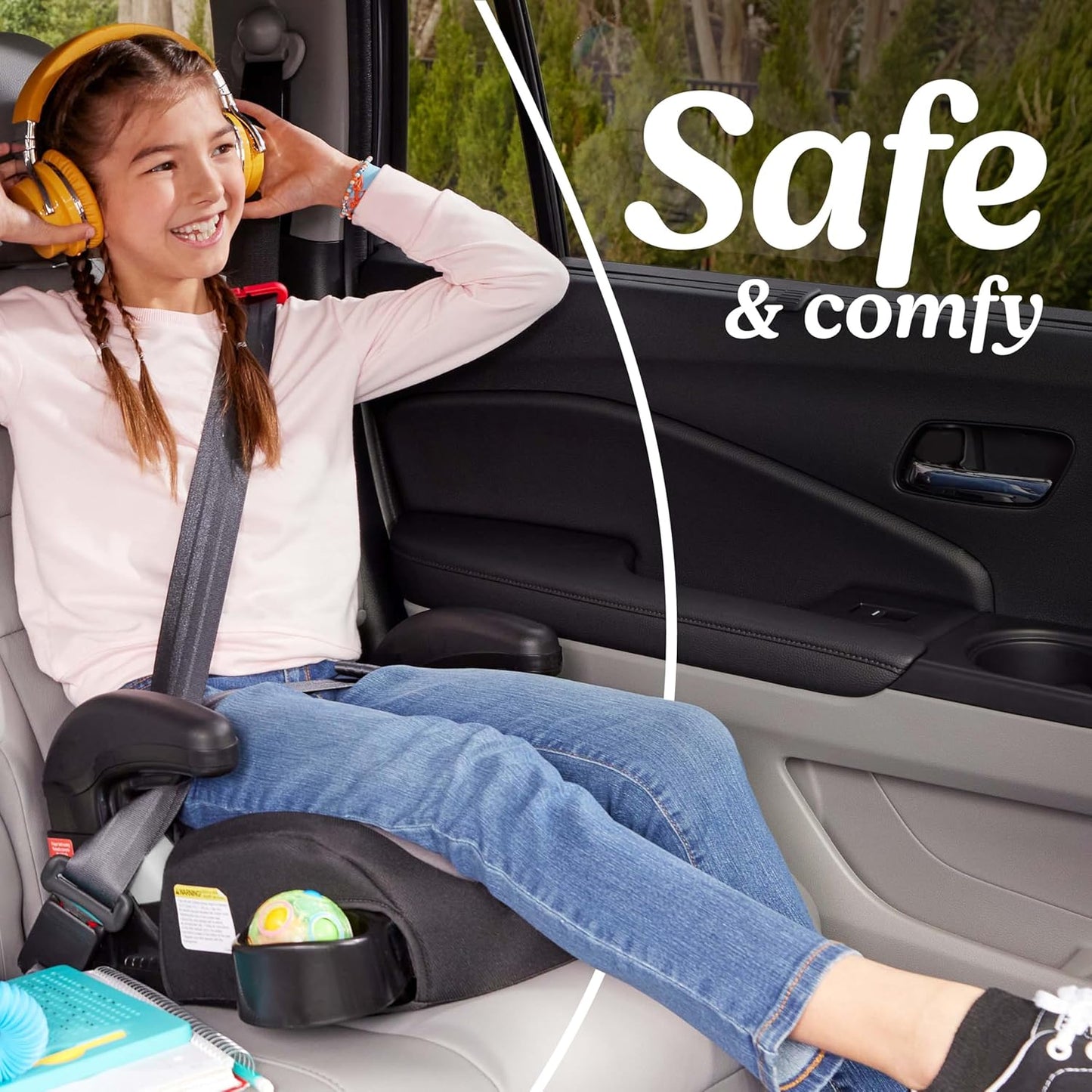 Child in a car seat with safety harness, smiling, with text 'Safe & comfy' in the background.